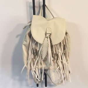 Small cream colored back-pack style purse